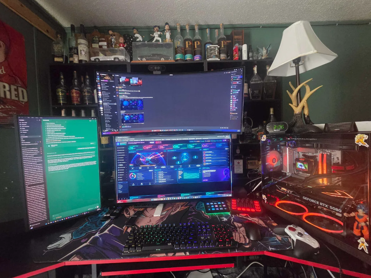 Wide view of Scott's three-display desk setup beside the red-lit Downum Cyber PC tower, with RAGNAROK visible on the center display.