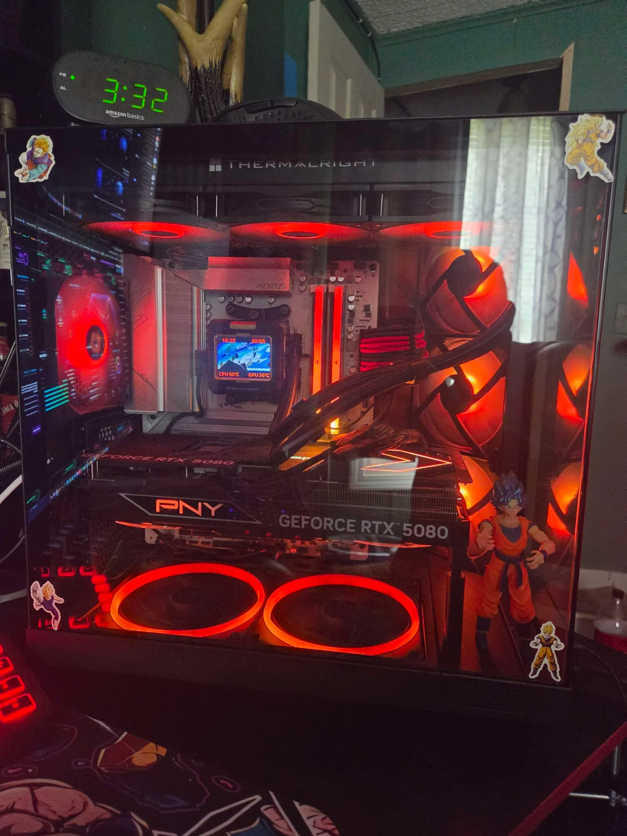 Close-up of the red-lit NZXT H6 Flow PC with Ryzen 9 9950X, PNY GeForce RTX 5080, Thermalright cooler, AORUS motherboard, and NZXT fans.